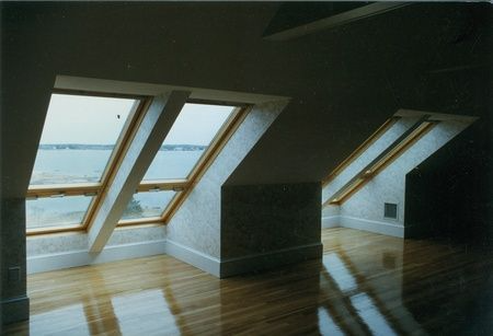 A room with a lot of windows and a view of the ocean