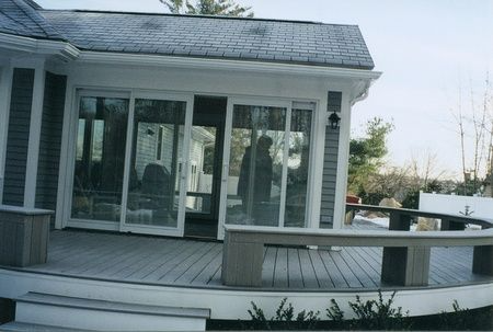 A house with a large deck and sliding glass doors