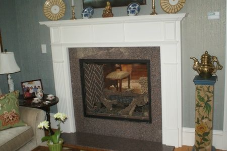 A living room with a fireplace and a couch