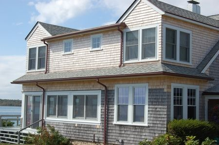 A large house with a lot of windows and a gray roof