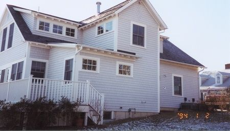 A white house with a black roof was built in 1994