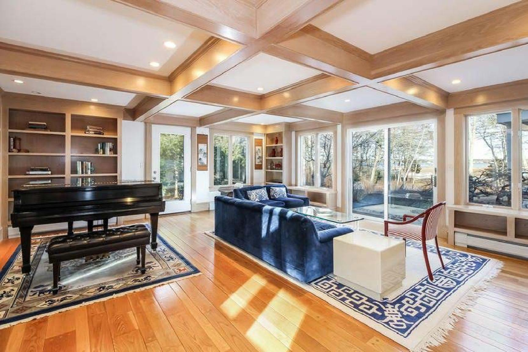There is a piano in the middle of the living room.