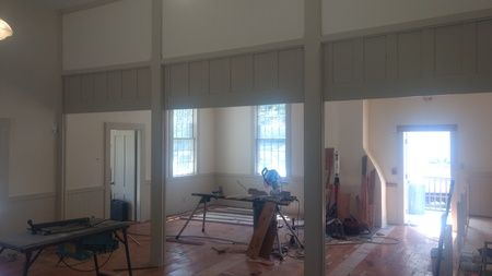 There is a table saw in the middle of the room.