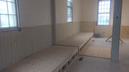 A room with two benches in it and a window.