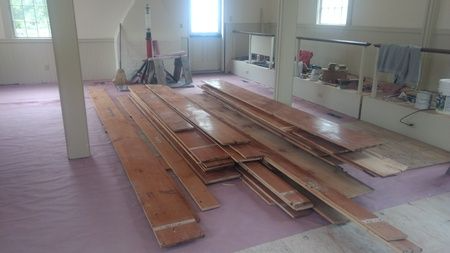 A room with a lot of wooden boards on the floor.