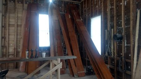 A room with a lot of wooden beams stacked on top of each other.