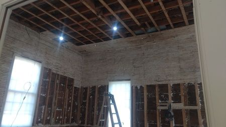 A room with a wooden ceiling and a ladder in it.