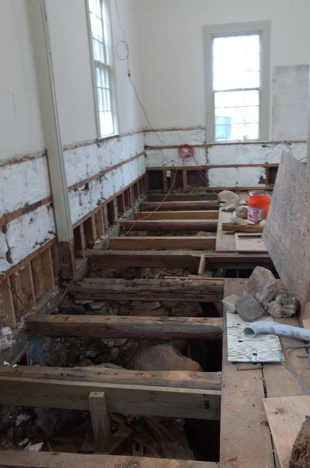A room with a lot of wooden beams and a window.
