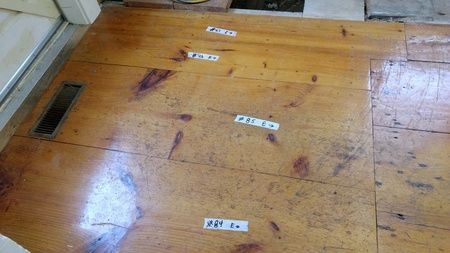 A close up of a wooden floor with stickers on it.