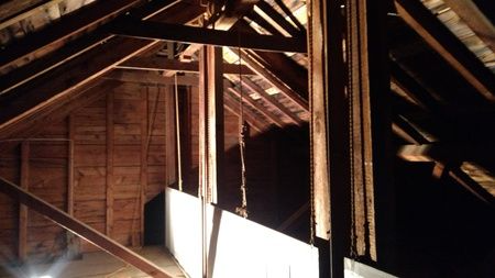 A dark attic with a lot of wooden beams