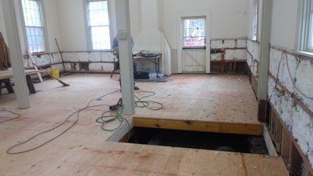 A room with a wooden floor and a hole in the floor.