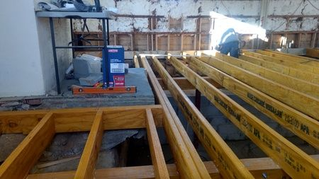 A wooden floor is being built in a room.