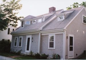 A house with a gray roof and white trim