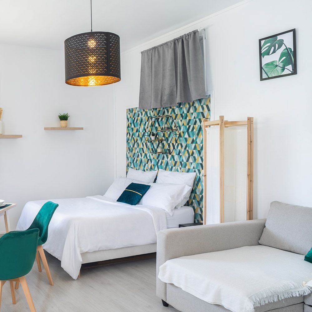 There is a bed and a couch in the room.