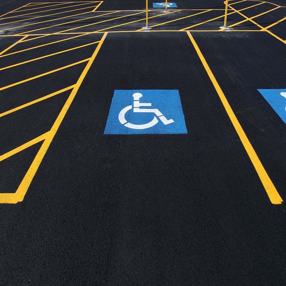 A parking lot with a handicap sign painted on it