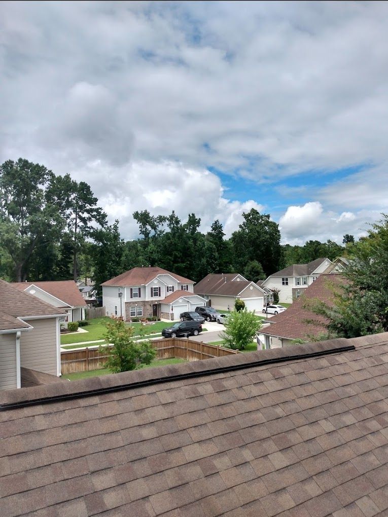 A rooftop view of a residential neighborhood on a cloudy day