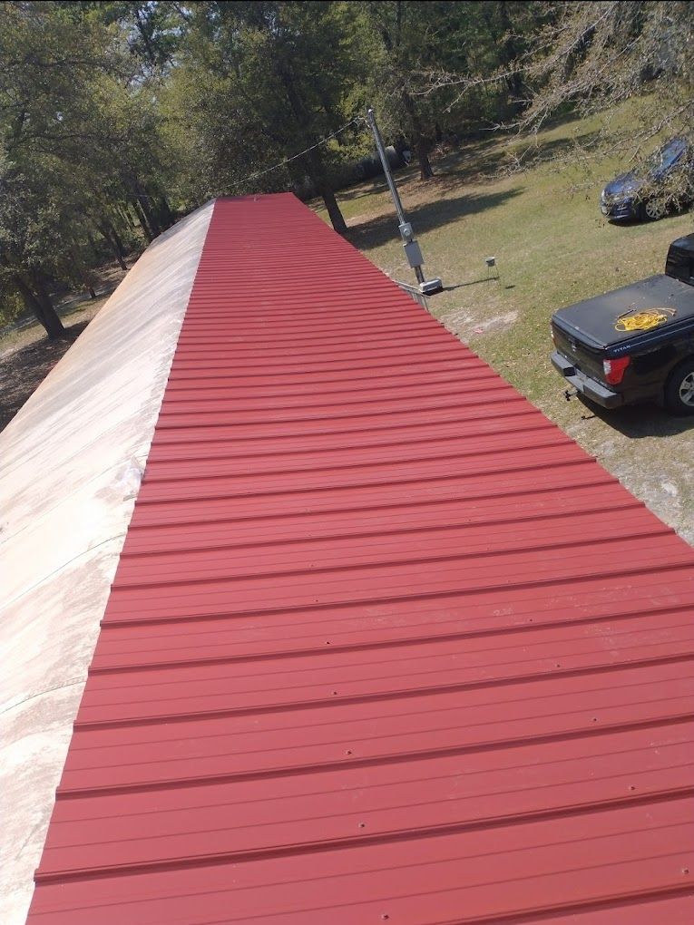 A red roof with a truck parked on the side of it.