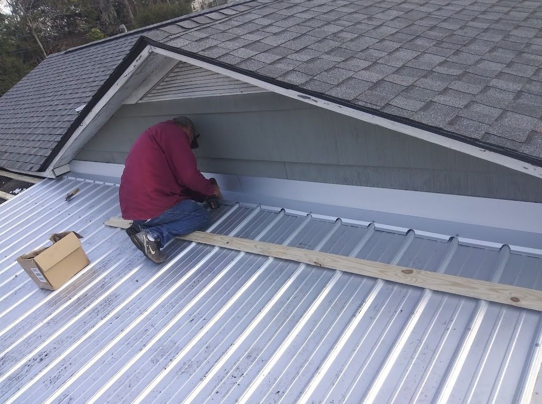 A man is working on the roof of a house.
