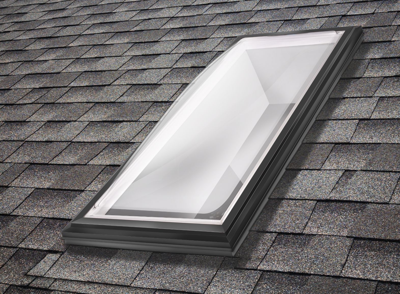 A skylight is sitting on top of a shingle roof.