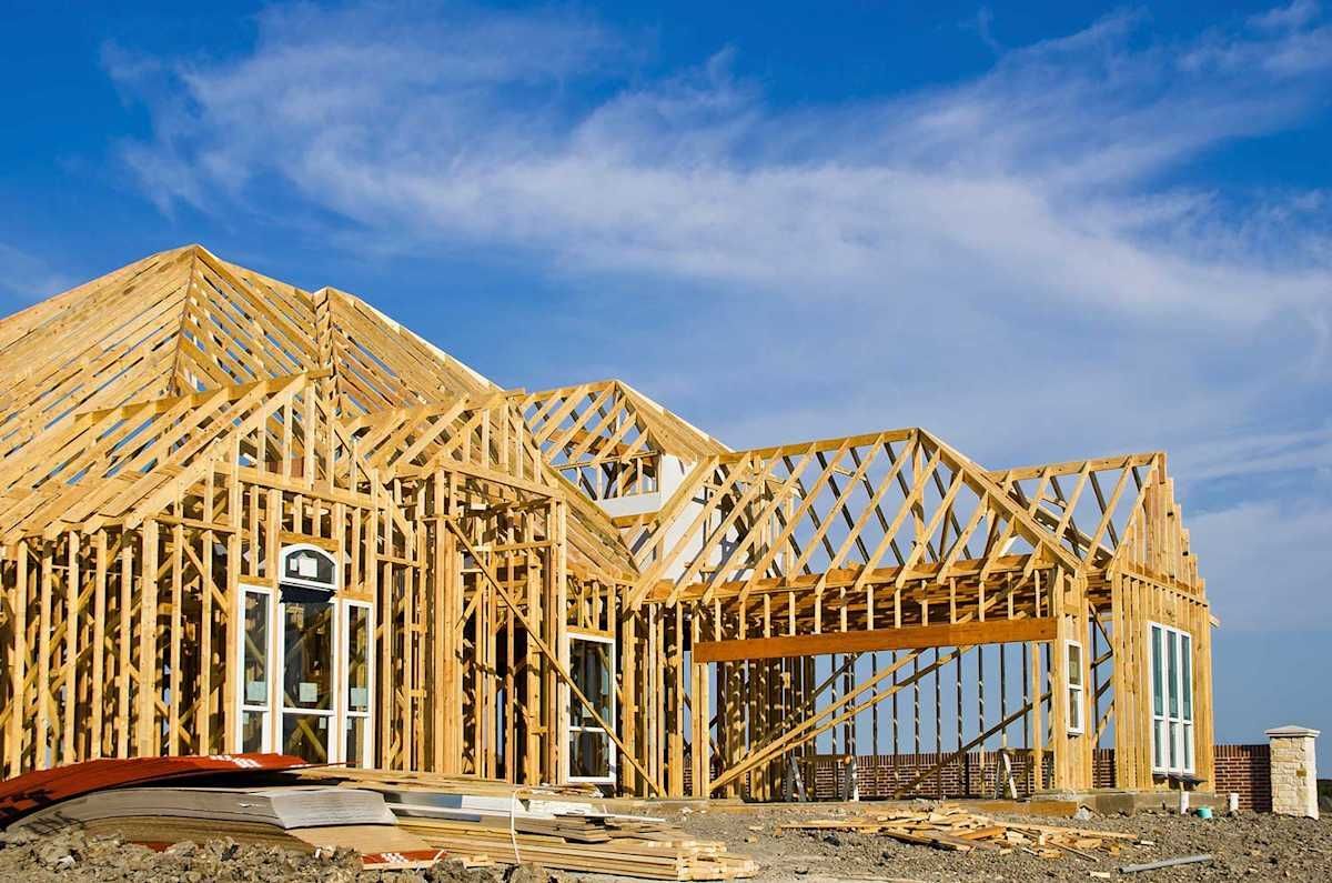 A house is being built with a blue sky in the background.