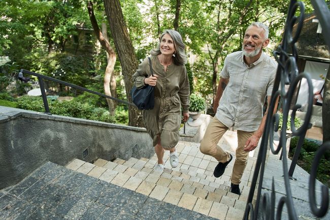 A man and a woman are walking down a set of stairs.