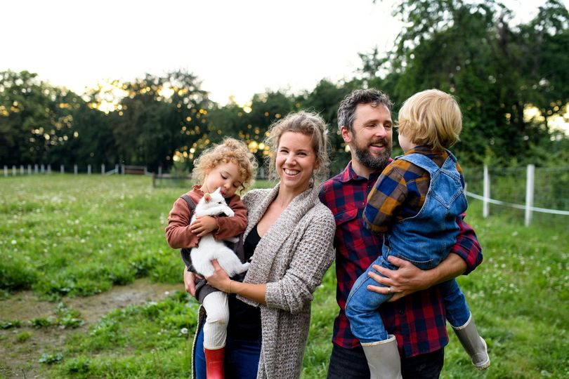 A family is posing for a picture in a field.