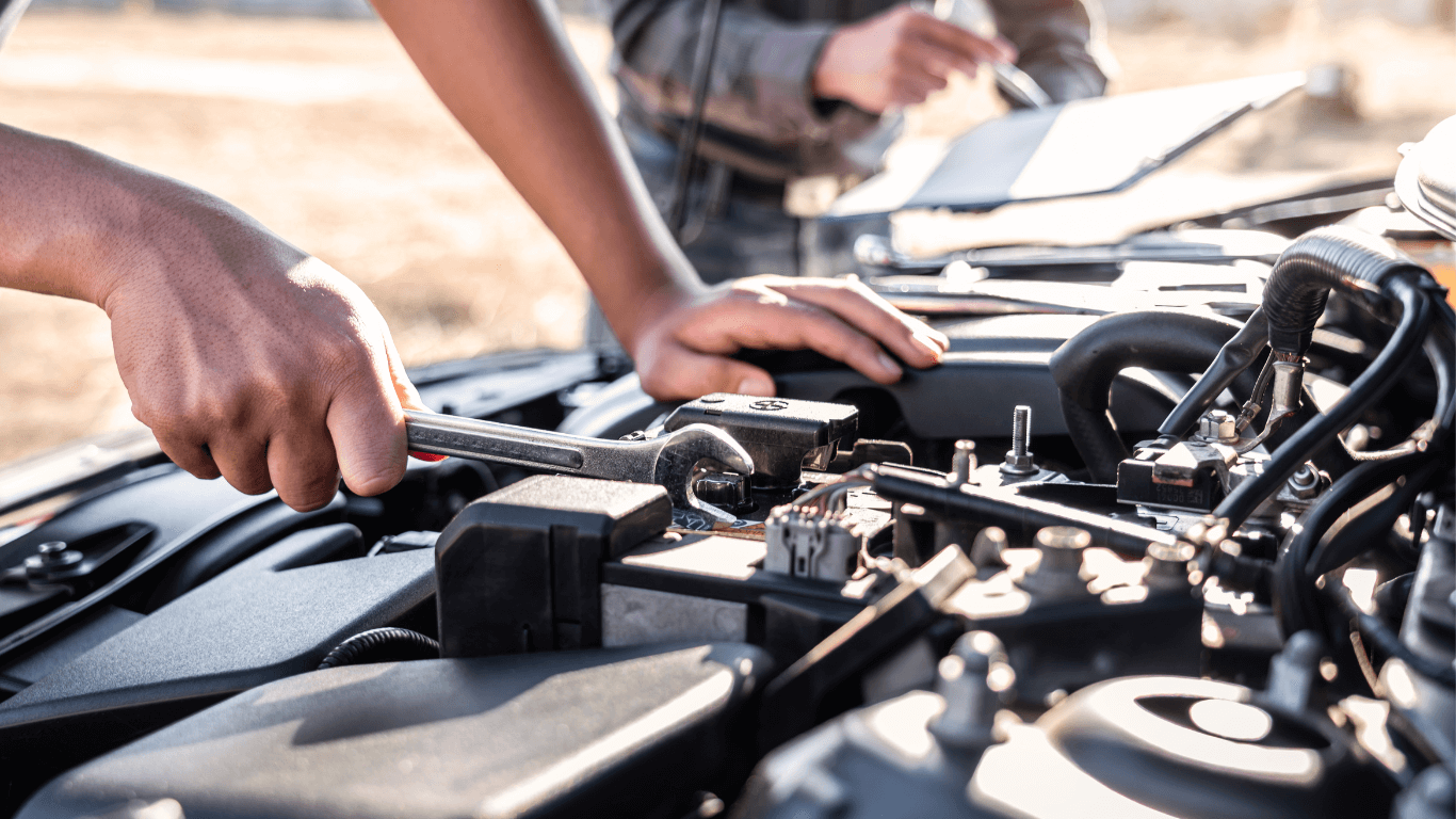 Mechanic under the hood of a car during the day in Concord, NC