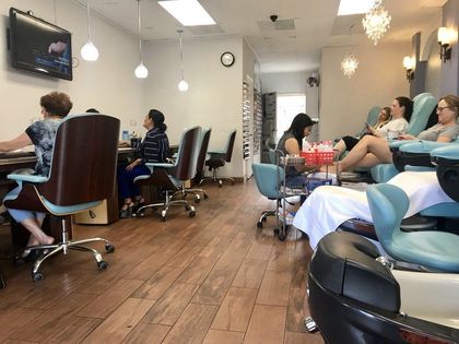 A Group Of People Sitting In Chairs In A Nail Salon — San Diego, CA — Summer Nails and Spa