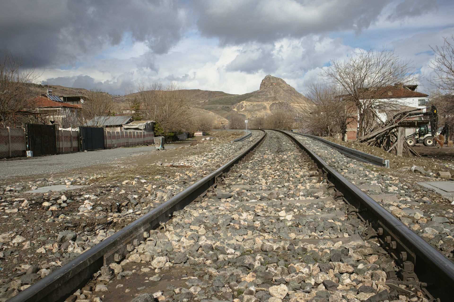 A train track with a mountain in the background.