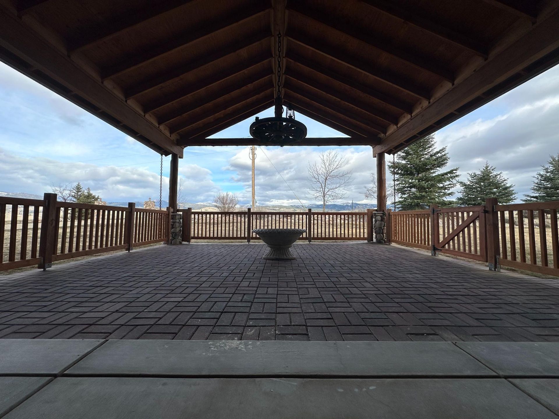 Modern kitchen with white cabinets, island, stainless steel fridge, and wooden floors.