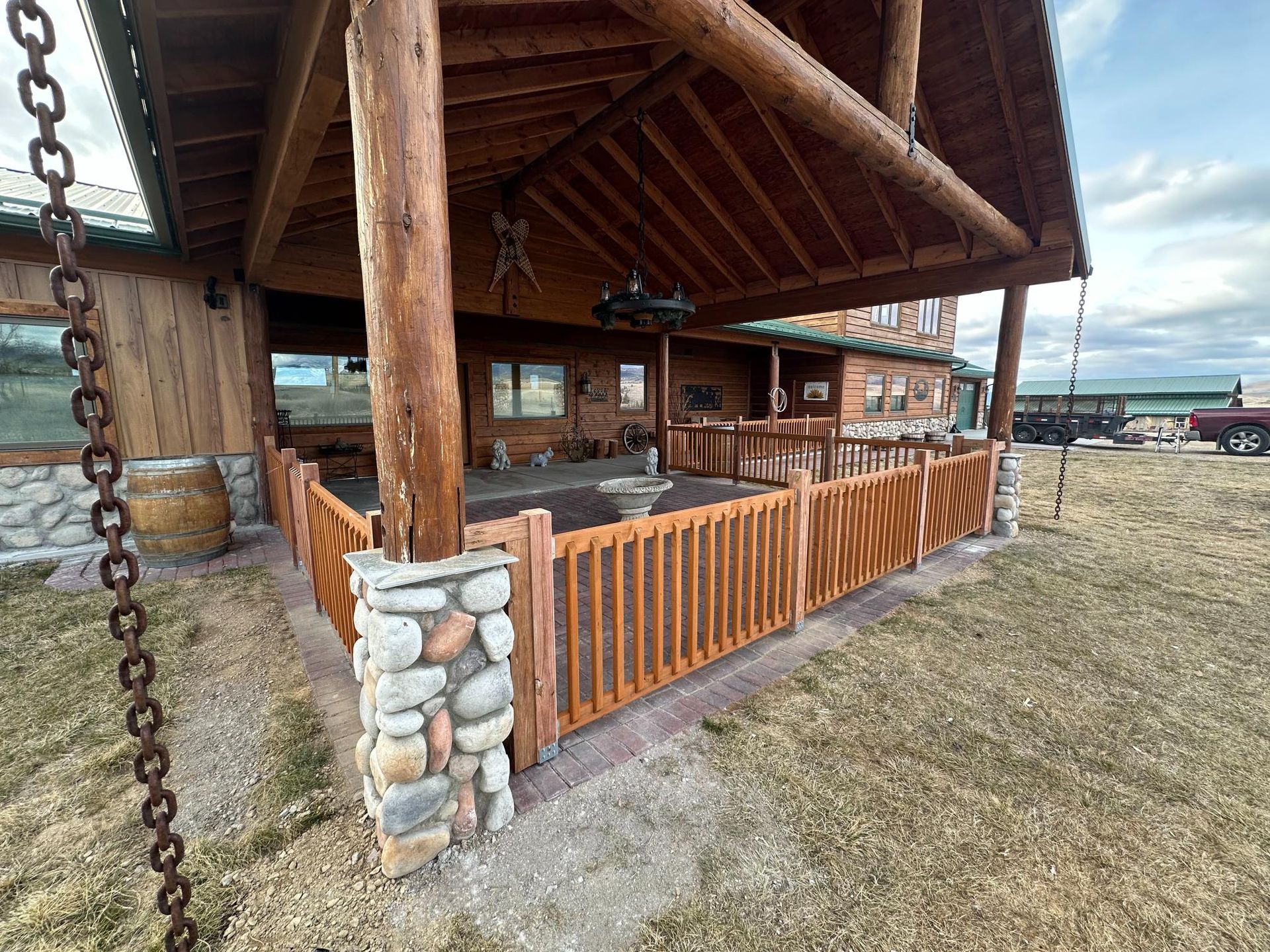 A wooden mezzanine with stairs inside a large industrial building, illuminated by overhead lights.
