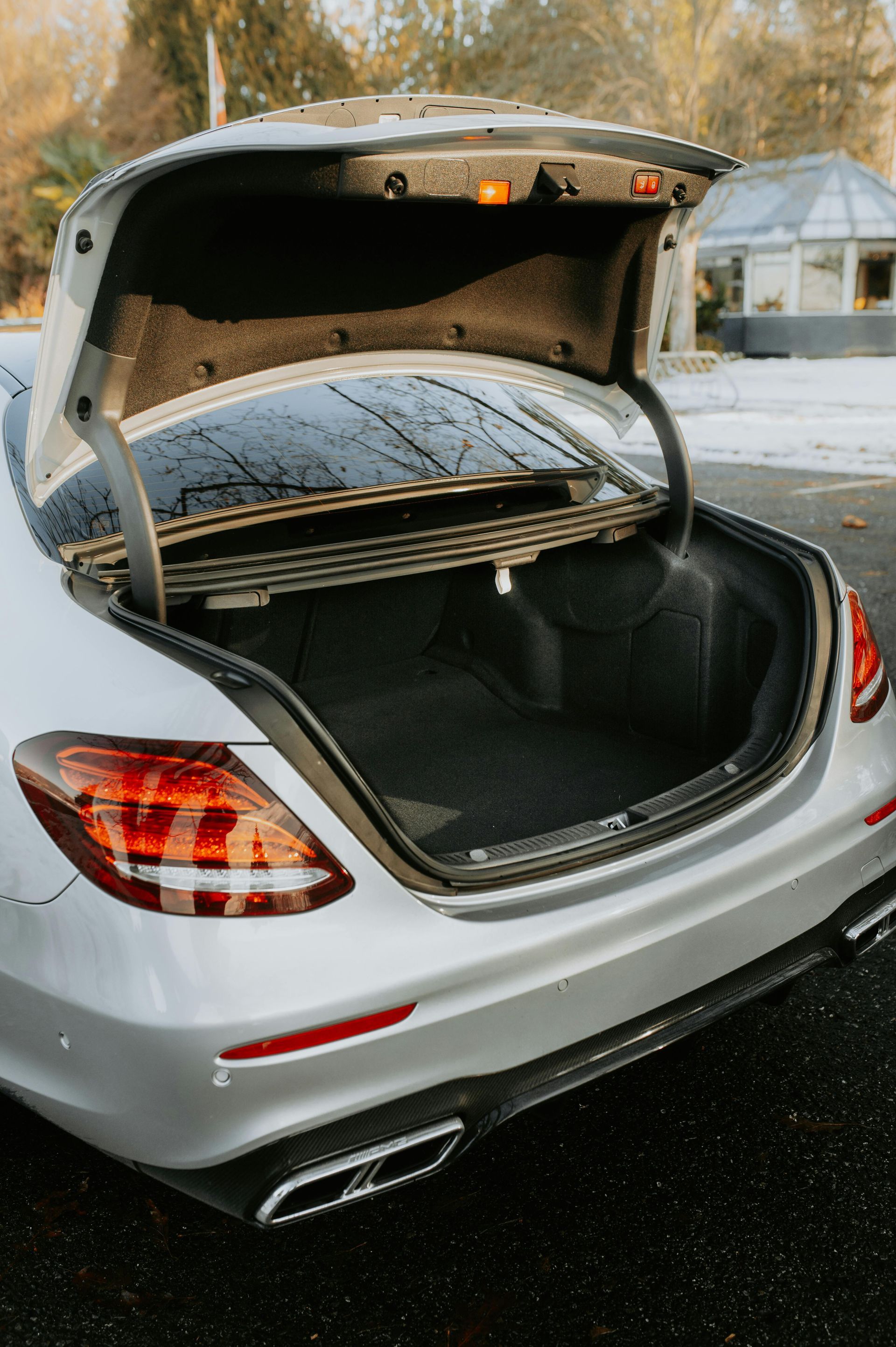 Silver Mercedes-Benz trunk open, revealing a dark interior | Space Center Automotive