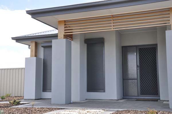 grey roller shutters on house