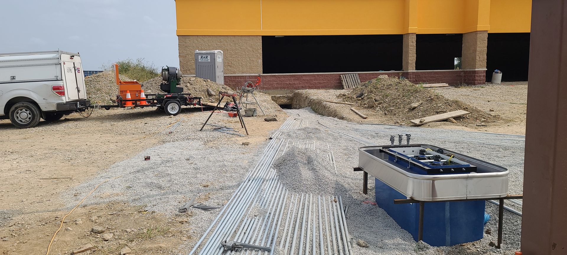 A truck is parked in front of a building under construction.