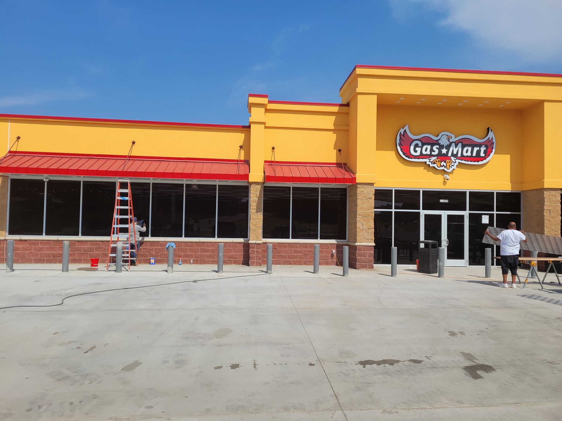 A gas mart is being painted yellow and red