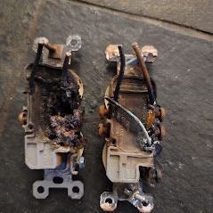 Two light switches are sitting next to each other on a table.
