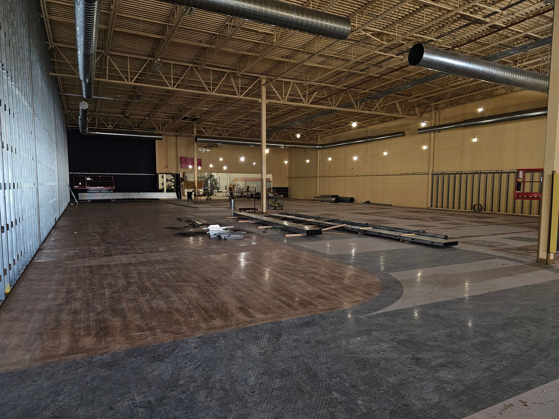 A large empty warehouse with a wooden floor