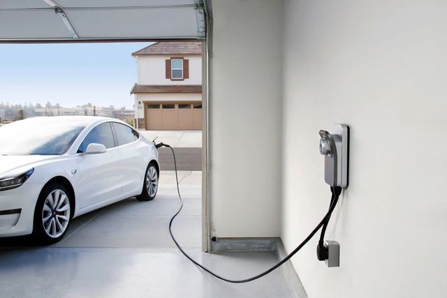 Two security cameras are attached to a gray wall.