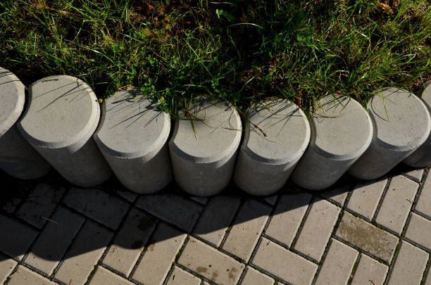 A row of concrete blocks sitting on top of a brick sidewalk