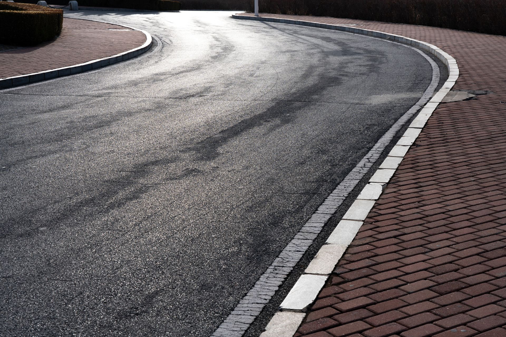 A curvy road with a white line on the side of it