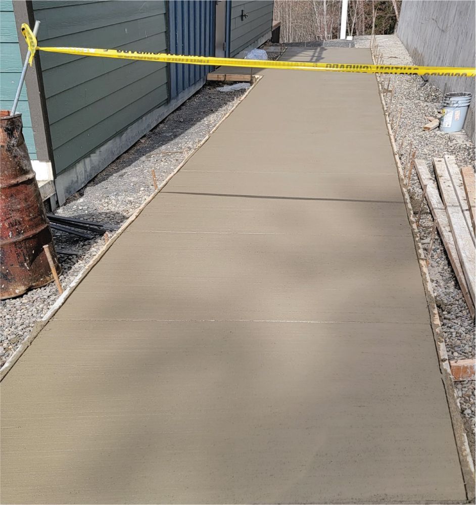 A concrete walkway with a yellow caution tape on it