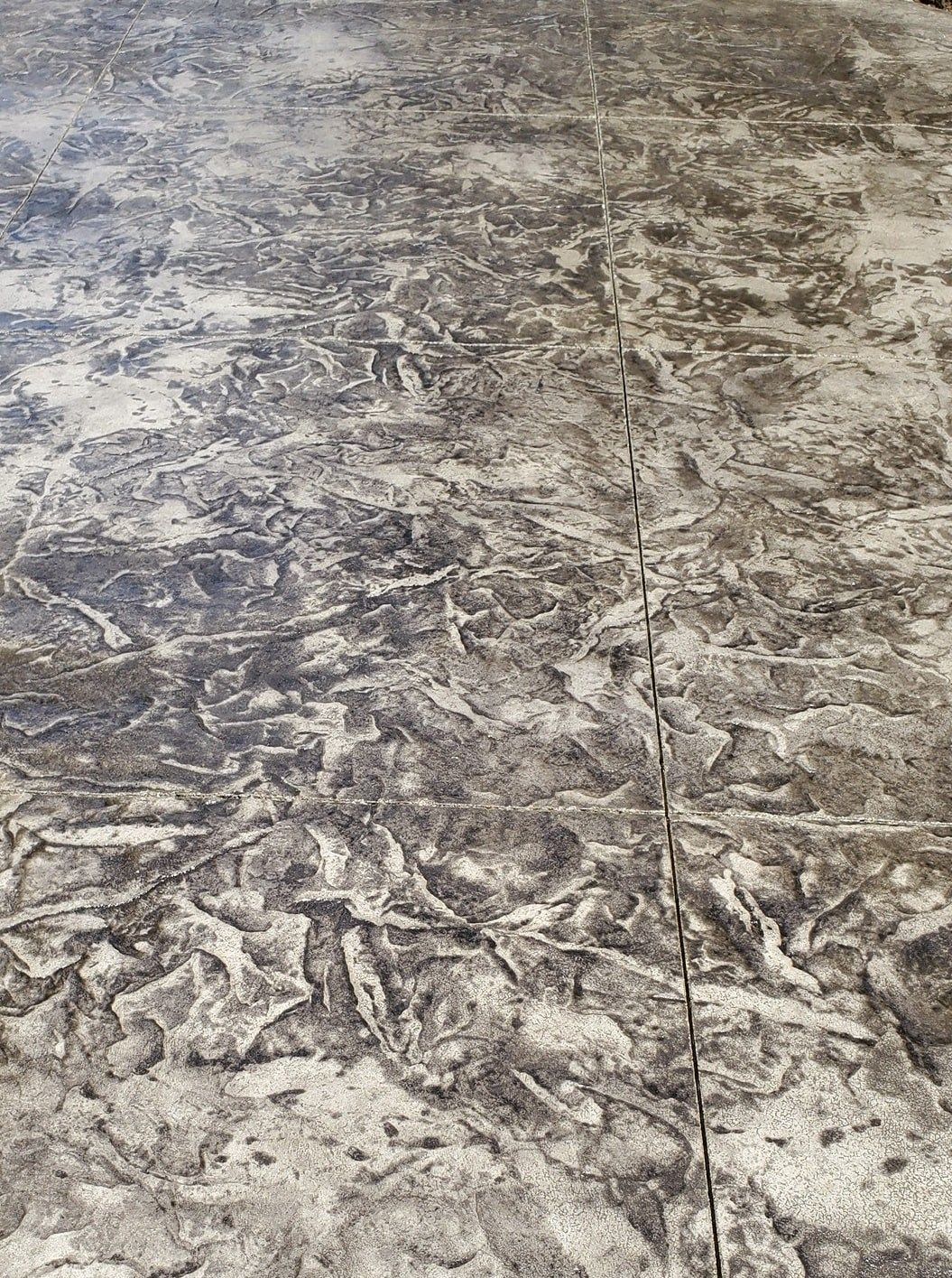 A close up of a concrete floor with a marble texture.