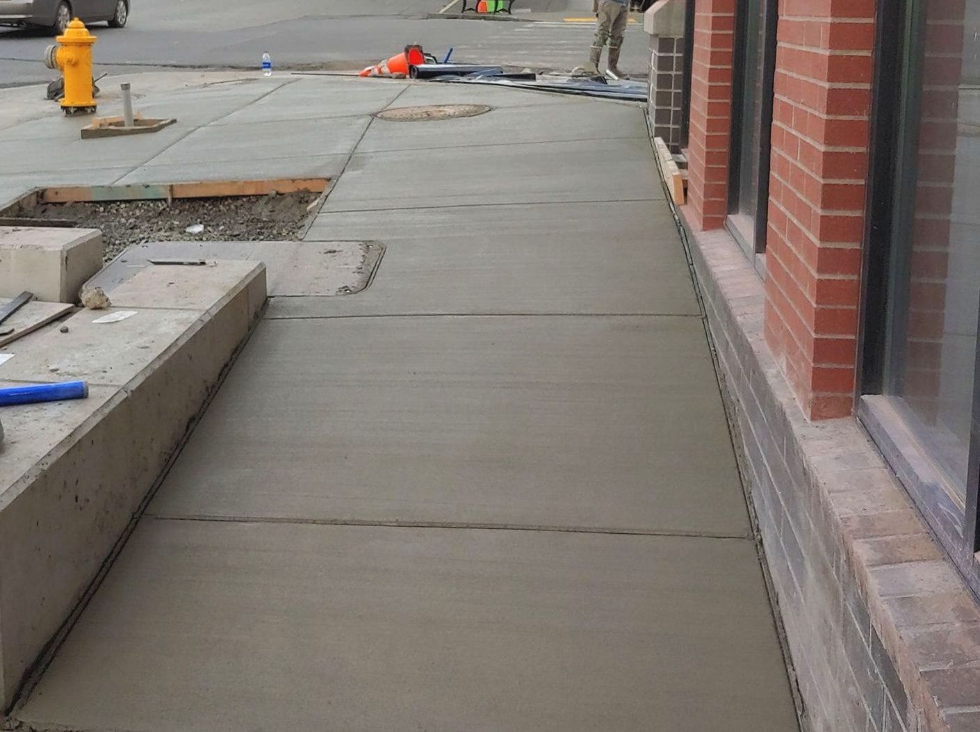 A sidewalk is being built next to a fire hydrant