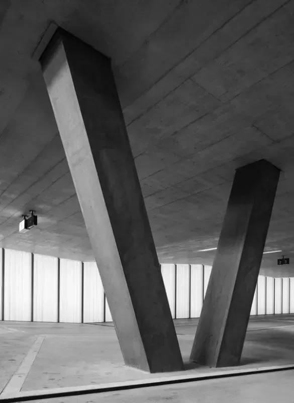 a black and white photo of a parking garage with columns and windows of a commercial concrete in Bellingham Washington.