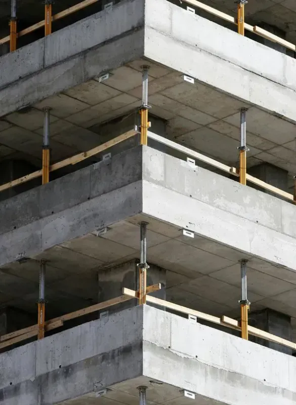 A building under construction with only the concrete foundations.