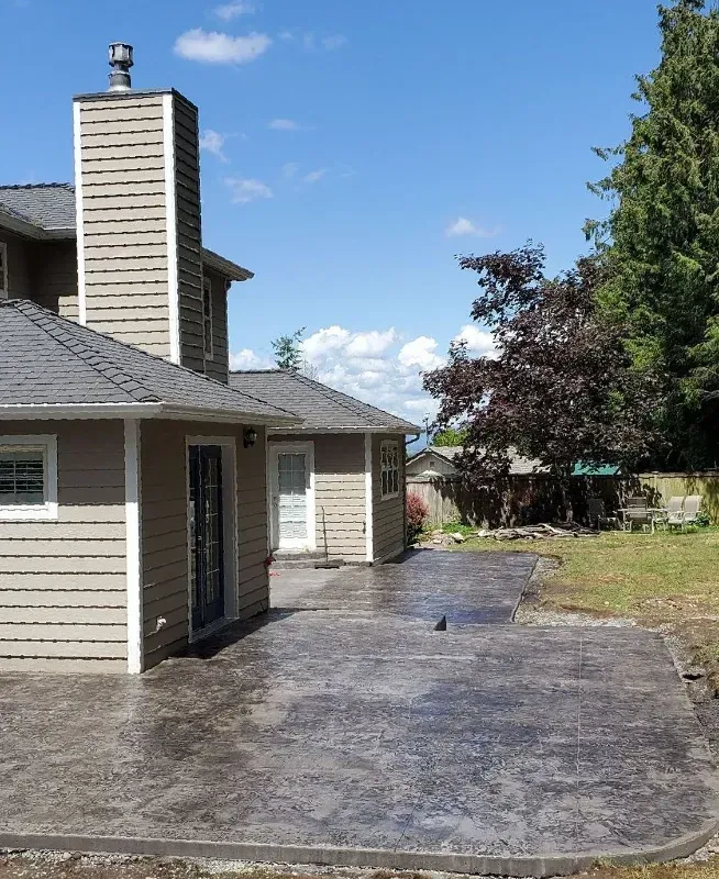 a house with a chimney on top of it standing on a concrete patio in Bellingham Washington.