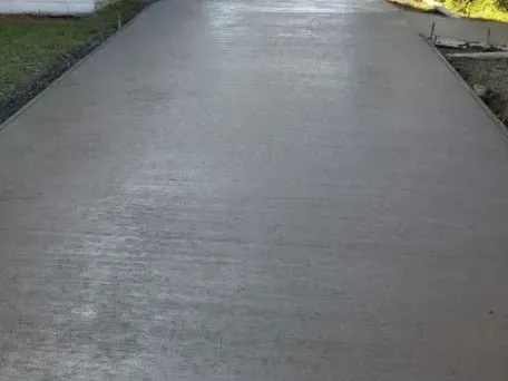 a concrete broom finished driveway is being built next to a house in Bellingham Washington.