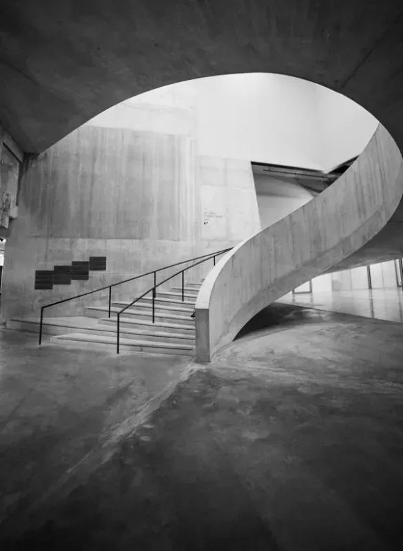 a black and white photo of a spiral staircase in a building and concrete floor finish in Bellingham Washington.