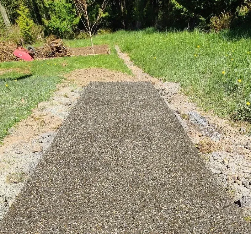 a sand finished concrete walkway going through a grassy field in Bellingham Washington.