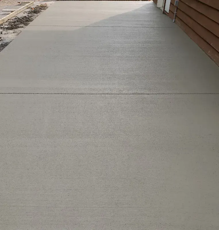 a sand finished concrete walkway is being built in front of a house in Bellingham Washington.